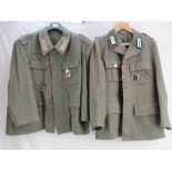 A reproduction WWII German tunic in the Wehrmacht style with 25 Assault badge and Anti Partisan