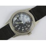 A US Vietnam War era military issue manual wristwatch, dated 1969 with black canvas strap.