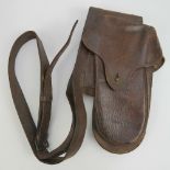 A Boer War brown leather saddle bag with compartments for two pistols, complete with brass fittings.
