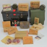 A WWII British ARP Wardens emergency tin, containing; ration tin with leather strap,