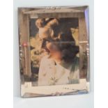 An Art Deco blush pink mirrored glass photo frame having slide out backing and believed to have