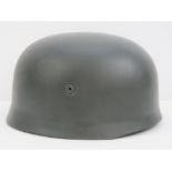 A reproduction WWII German Paratrooper (Fallschirmjager) helmet, with padded liner and chinstrap.