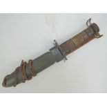 A US Military issue M1 carbine bayonet in scabbard, as used in WWII, Korea and Vietnam conflicts,