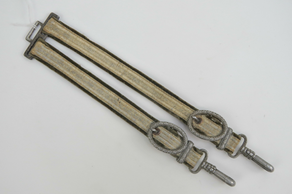 A set of WWII German Army Officers dagger hangers in green with white metal fittings and silver