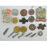 A collection of WWII German tinnie badges including stick grenade and sea mine,