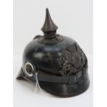 A WWI German Pickelhaube helmet having leather liner, strap and metal plate to front.