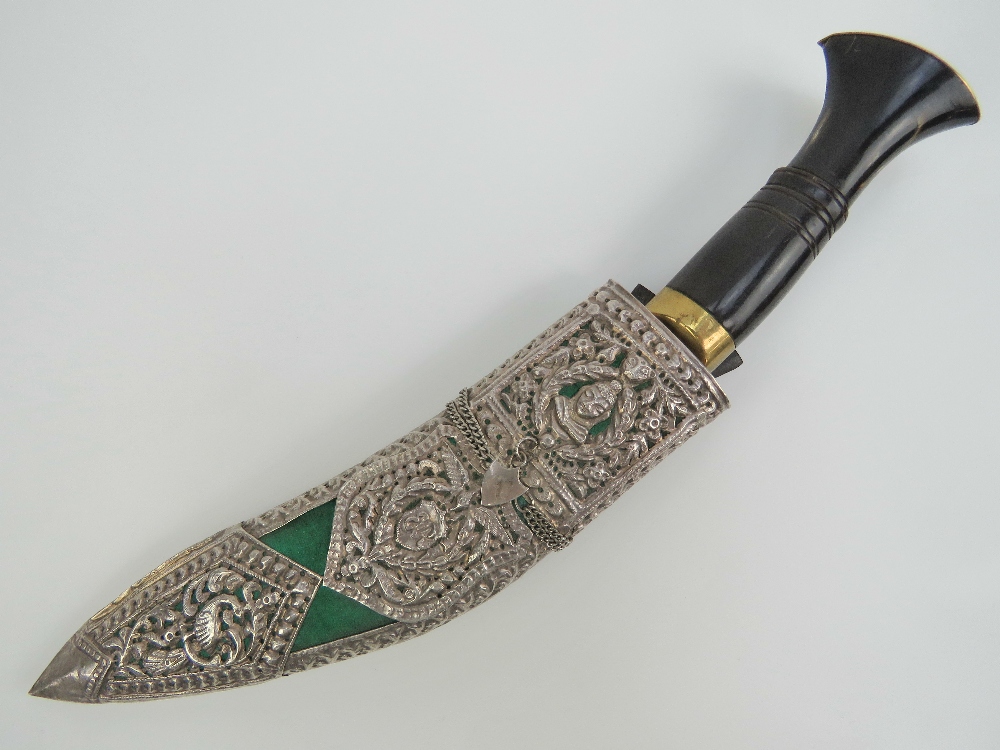 A fine quality Kukhri knife having curved decorated blade, brass and turned horn handle.