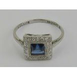 An Art Deco platinum and 18ct white gold sapphire and diamond ring having central square cut