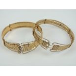 Two yellow metal bangles one having Greek key pattern upon, no apparent hallmarks, total weight 35.