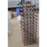 A wooden and metal bottle rack measuring 120 x 42cm, to hold 48 bottles.