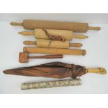 A vintage parasol having native American chief design to handle together with four wooden rolling