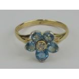 An aquamarine and diamond daisy cluster ring,