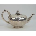 A Georgian HM silver teapot having chased floral decoration throughout, cast silver floral knop,