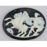 A cameo panel in black and white having classical figures upon and measuring 6 x 4.5cm.