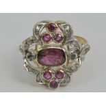 A vintage 14ct gold ruby and diamond cocktail ring of floral form having central rectangular ruby