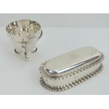 An HM silver conical egg cup raised over three scrolled supports, marked for Sheffield 1908.