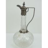A Victorian HM silver and cut glass claret jug complete with lid and having engraved star pattern