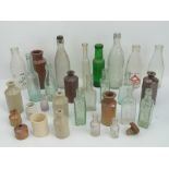 A quantity of assorted glass and stoneware bottles.