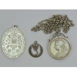 A Victorian silver commemorative coin in silver mount on white metal chain together with a Franklin