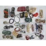 A quantity of assorted costume jewellery including carved bone and bead necklace,