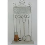 A contemporary shabby chic fire companion set comprising poker, tongs, shovel and brush,