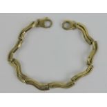 A heavy 9ct gold bracelet having eight double row wave pattern panels, hallmarked 375, 11.9g.