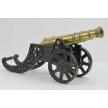 A Victorian cast iron and cast brass miniature cannon,