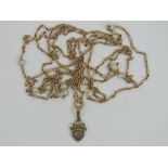 A delightful Edwardian 15ct gold and pearl chain measuring 156cm in length, stamped 15c to clasp,