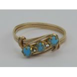 A yellow metal wirework ring set with three turquoise cabachons, size P, 1.6g.