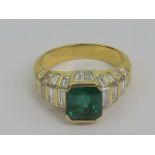 A large and impressive emerald and diamond ring, the emerald cut emerald being approx 2.