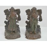 A pair of bronzed brass bookend being figure of male and female with trees beyond,