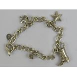 A HM silver Joy Everley 'Kiss' charm bracelet complete x shaped charm (RRP £169),