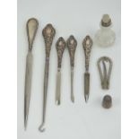 A set of four HM silver handled ladies dressing table items including button hook and nail file,