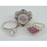 A 925 silver ring having pierced scrolling decoration and marked 'Karis' with lilac stones size N-O.