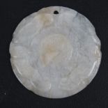 A mutton fat white jade disk pendant measuring 43mm dia and having carved Oriental patterns to