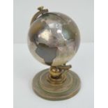 A delightful vintage desk clock in the form of a globe in brass and silver plate,