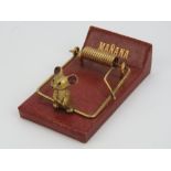 A Madler Moroccan covered paperclip in the form of a mouse trap complete with gilded mouse,