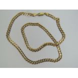 A 9ct gold flattened curb link chain measuring 54cm in length, hallmarked 375, 16.9g.
