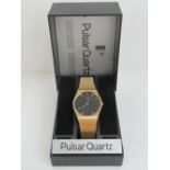 A Pulsar Quartz gold plated wristwatch having circular black ground face,