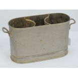 A silver plated champagne cooler for two bottles having twin end handles and measuring 35cm wide.