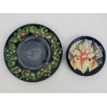 A William John Moorcroft plate decorated with leaves and berries, 18cm dia.