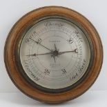A circular oak cased Edwardian barometer Callaghan and Co Bond street London. 23cm dia.