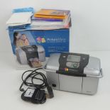 An Epson Picture Mate personal photo lab in box with guides and Kodak photo paper.