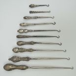 A sterling silver button hook together with nine other HM silver and steel button hooks,