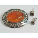 A silver and Baltic amber brooch, stamped 925 and measuring 3.8cm wide.