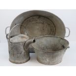 A vintage steel washing tub together with a steel jam pan with swing handle and a watering can.