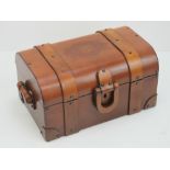 A tan leather jewellery box in the form of a dome top travelling trunk,