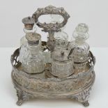 A silver plated and cut glass cruet set comprising galleried tray raised over four feet,