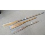 Three vintage wooden oars.