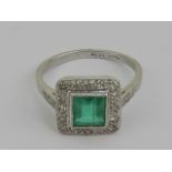 An Art Deco platinum emerald and diamond ring having central square cut emerald approx 0.